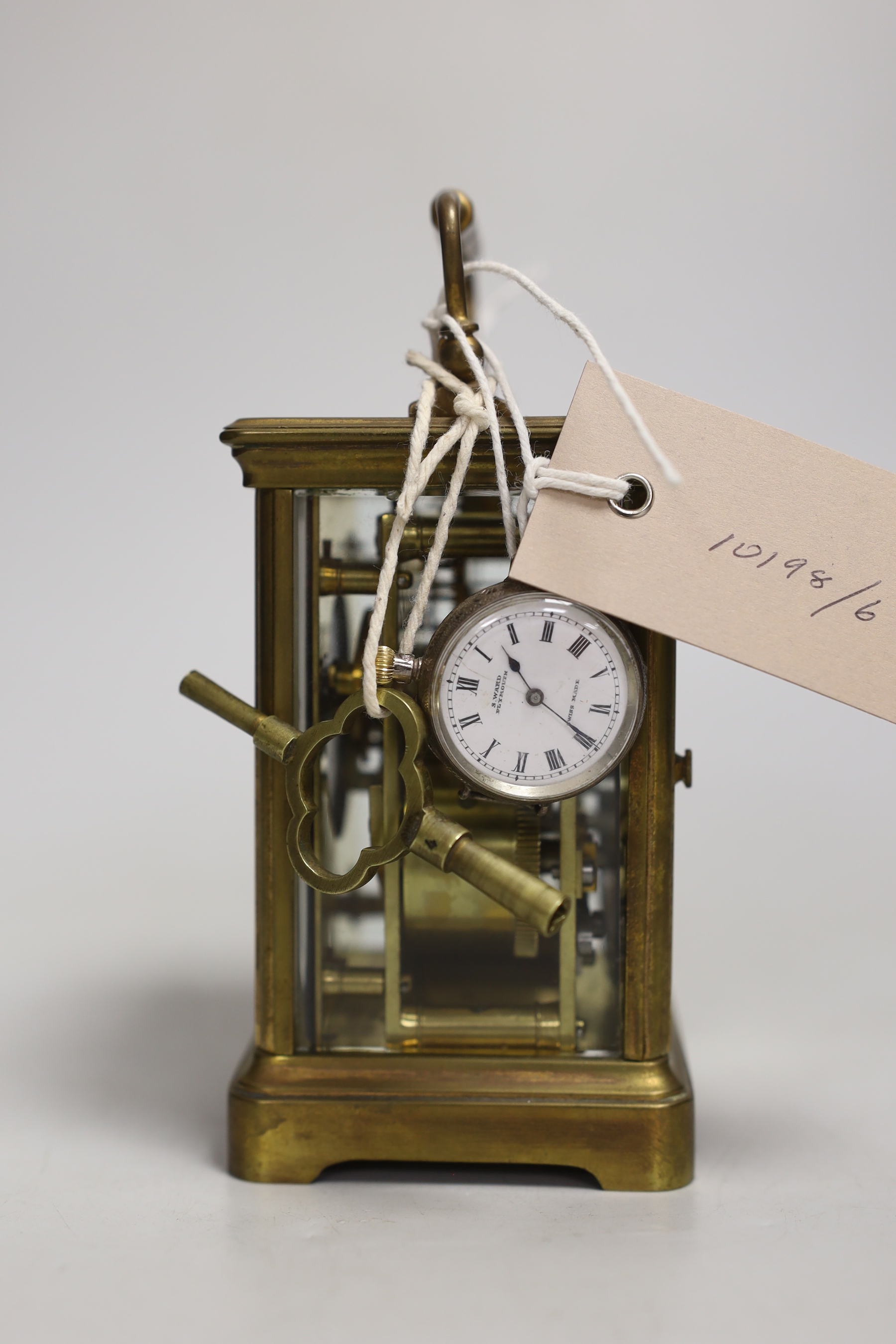 A brass carriage clock and a silver watch, clock 12cm high